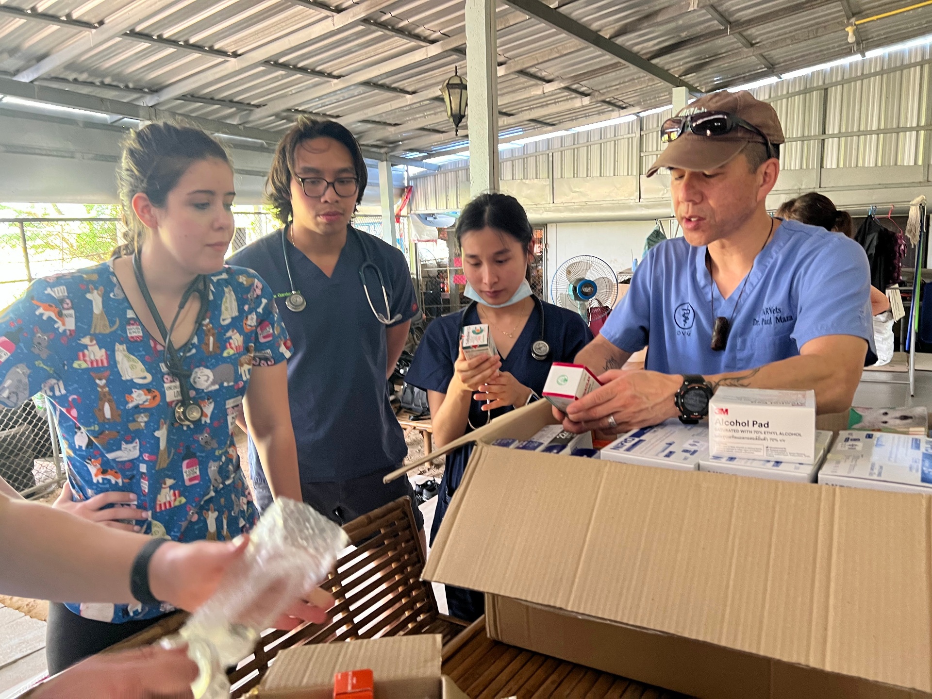 Dr. Paul Maza reviewing medical supplies with FARVets students and clinicians before a clinic day