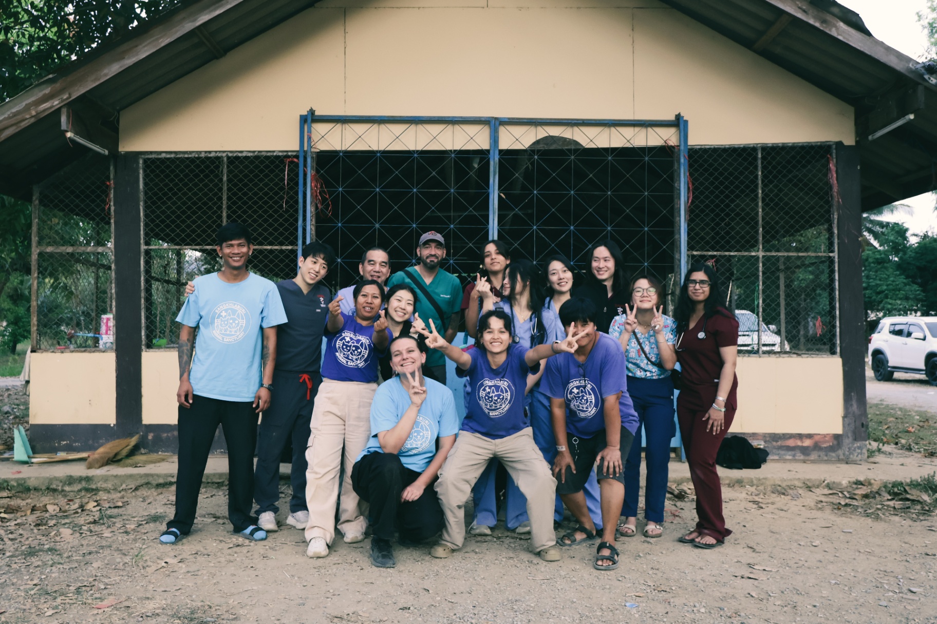 FARVets team and partners posing together in front of the Sangkhlaburi Animal Sanctuary in Thailand